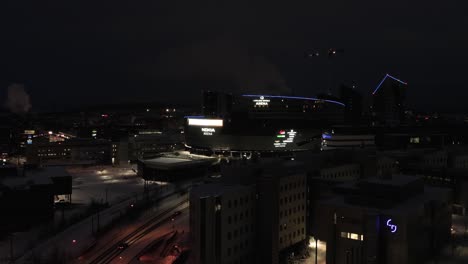 Nokia-areena,-snowy,-winter-night-in-Tampere,-Finland---ascending,-Aerial-view