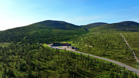 Aerial-view-approaching-the-Lapland-hotel-Pallas,-sunny-summer-day-in-Finland