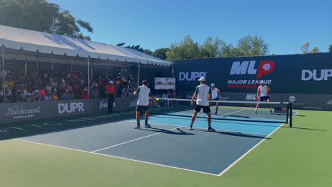 Men-playing-an-intense-game-of-doubles-at-the-MLP-in-Newport-Beach,-California,-USA---fixed-wide-view