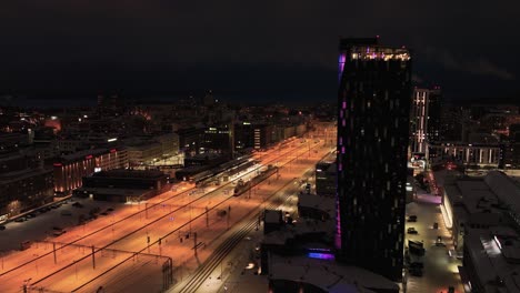 Aerial-view-of-cityscape-at-the-train-station,-night-in-Tampere,-Finland---vertigo-effect