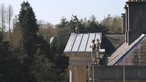 Aerial-moving-around-the-roof-of-glynllifon-estate-to-reveal-the-glorious-atrium-and-the-statues-mounted-above