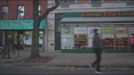 Slow-motion-side-shot-of-a-street-of-Brooklyn-from-a-driving-car