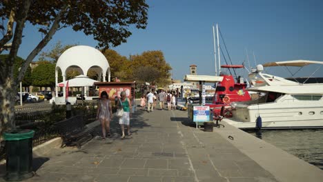 Pasarela-En-La-Costa-De-La-Ciudad-De-Rodas-Con-Coloridos-Barcos.