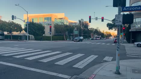 Traffic-in-downtown-Santa-Monica-Arizona-Avenue,-sunny-evening-in-Los-Angeles,-USA---static-view