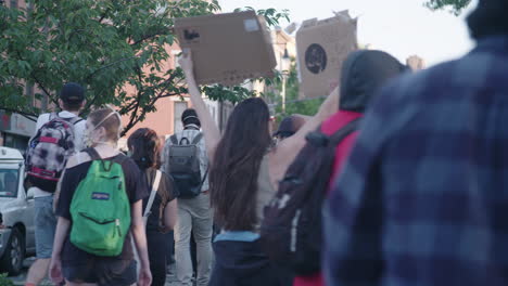 Back-Shot-of-group-of-Protesters-walking-and-holding-signs-in-NYC-during-BLM-protest-slow-motion