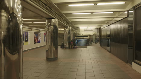 Homeless-on-subway-hallway-with-suitcases-during-coronavirus-outbreak