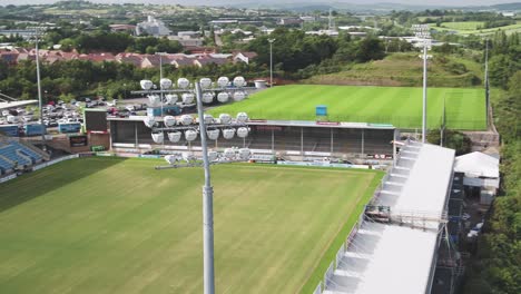 Aerial-of-the-M5-motorway,-sweeping-around-to-reveal-the-Exeter-chiefs-stadium-with-the-flood-light-a-focus-in-the-shot