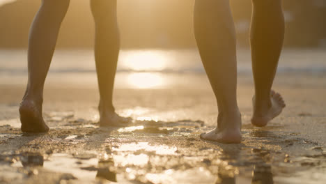 Two-people-walking-on-the-sand