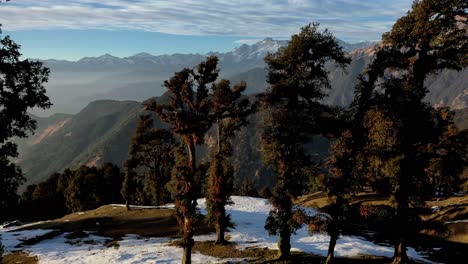 Aerial-drone-view-super-lots-of-snow-is-seen-and-big-mountains-are-visible-behind