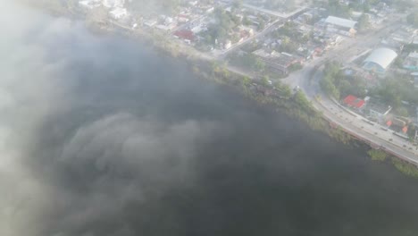 A-foggy-and-cloudy-aerial-shot-of-a-local-town-located-in-the-outskirts-of-the-city-of-Tulum,-Mexico