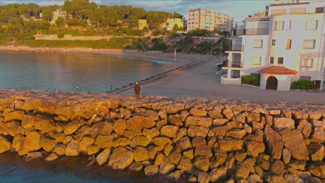 Tourist-visiting-Roc-de-Sant-Gaieta-Village-at-golden-hour