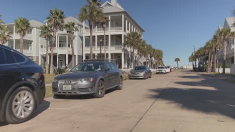 A-bicycle-point-of-view-shot-riding-past-beach-houses-in-Beachtown,-Galveston,-Texas