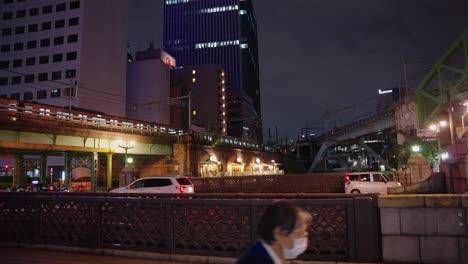 Static-slow-motion-shot-as-tokyo-commuter-train-arrives-at-station