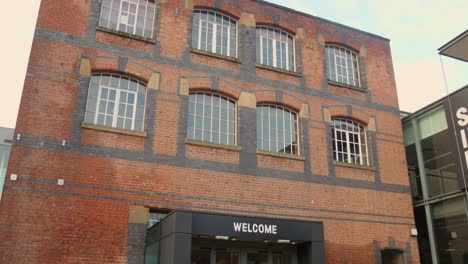 Low-angle-profile-view-of-exterior-architecture-of-vintage-Science-and-Industry-Museum-during-cold-daytime-in-Manchester,-England