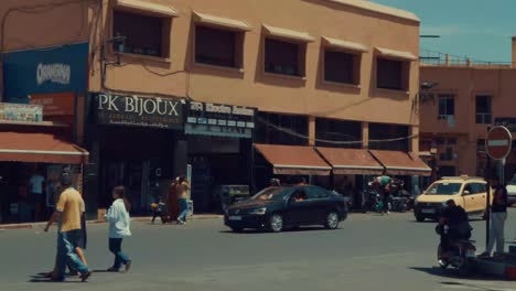 Busy-street-with-Tourist-and-locals-on-front-of-Jamaa-El-Fna-square-in-Marrakech