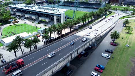 Drone-aerial-still-landscape-Gosford-stadium-waterfront-cars-traffic-palm-trees-on-Brian-McGowan-bridge-city-travel-tourism-transport-Central-Coast-Australia