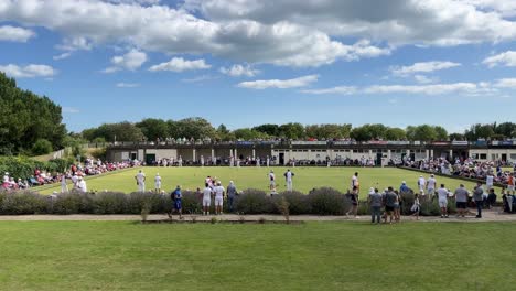 Crowds-gathered-at-a-outdoor-summer-crown-green-bowling-match,-competition