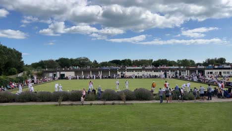 Crowds-gathered-at-a-outdoor-summer-crown-green-bowling-match,-competition