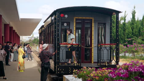 Da-Lat-Railway-Station---Photographer-Takes-Photos-of-People-by-Vintage-Train-on-Platform-Crowed-with-Tourists