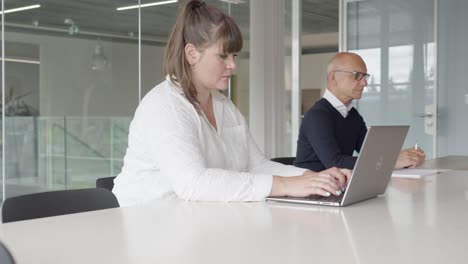 Profesionales-Que-Trabajan-En-Un-Escritorio-De-Oficina-Corporativa