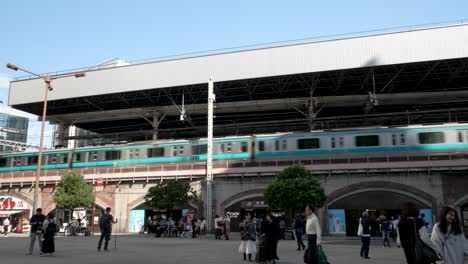 Shimbashi-Station-SL-Square-With-Toei-Line-Train-Passing-Overhesd