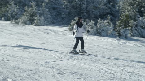 Young-Female-skier-sliding-fast-snowy-slope-slow-motion-winter-sunny-day