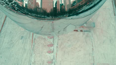 Ascending-perspective-above-Chicago's-renowned-photo-location,-Cloud-Gate,-also-recognized-as-"The-Bean,"-on-a-chilly-winter-day