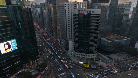 Aerial-Jammed-Car-Traffic-Hyperlapse-in-Gangnam-Main-Street-at-Sunset-in-Seoul,-Busy-Road-Crossroads-in-City-Center