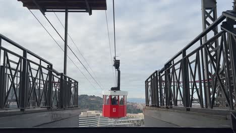 External-view-of-a-classic-and-old-red-and-white-cable-car-in-Barcelona-city,-Spain