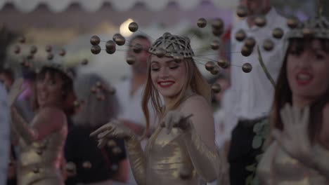 Celestial-Elegance:-Golden-Clad-Dancers-with-Solar-Hats-Adorned-with-Planetary-Orbs