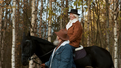 Woman-sitting-on-a-horse-near-the-woods