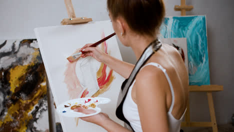 Woman-doing-a-painting-indoors