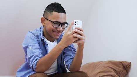 Young-boy-using-phone-on-bed