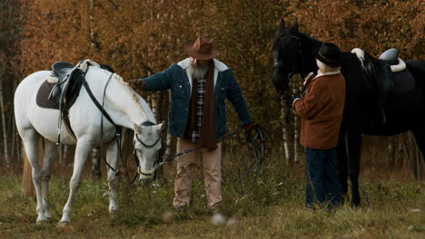 Mature-couple-with-their-horses