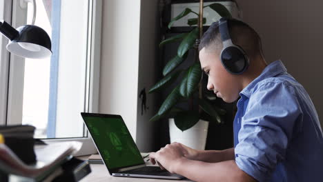 Boy-using-laptop-on-her-desk