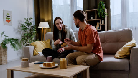 Couple-sitting-on-the-sofa-at-home