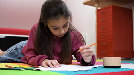 Girl-drawing-on-papers-at-thome