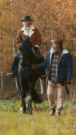 Woman-sitting-on-a-horse-near-the-woods