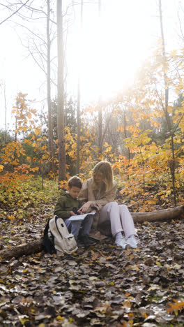 Mother-and-son-sitting-at-the-forest