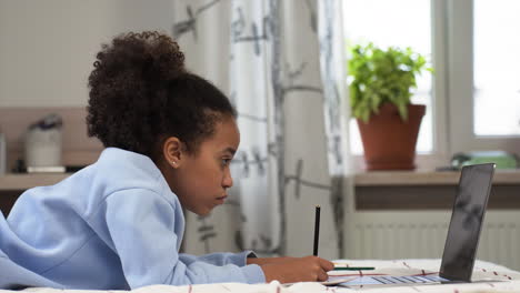 Girl-drawing-on-bed