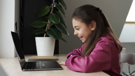 Girl-using-laptop-on-her-desk