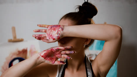 Happy-woman-with-dirty-painted-hands