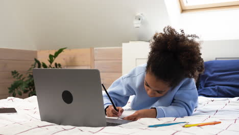 Girl-drawing-on-bed