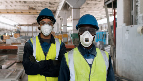 Men-wearing-protective-gear-in-factory
