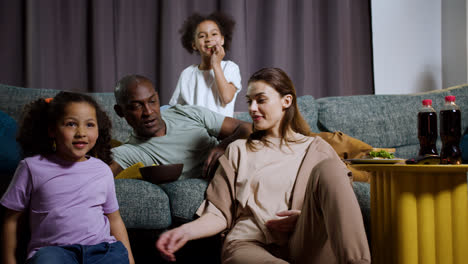 Kids-with-parents-watching-film-at-home