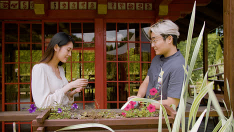 Japanese-couple-having-tea-and-talking-while-they-are-on-a-japanese-house-porch