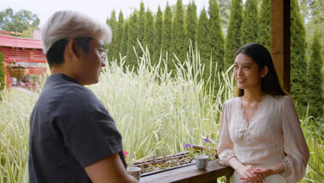 Japanese-couple-having-tea-and-talking-while-they-are-on-a-japanese-house-porch