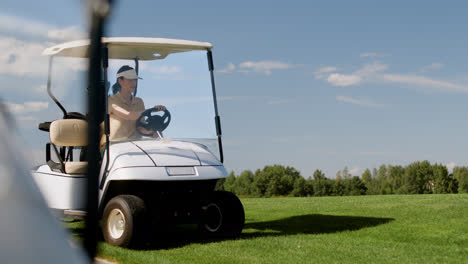 Caucasian-woman-driving-a-car-on-the-golf-course.