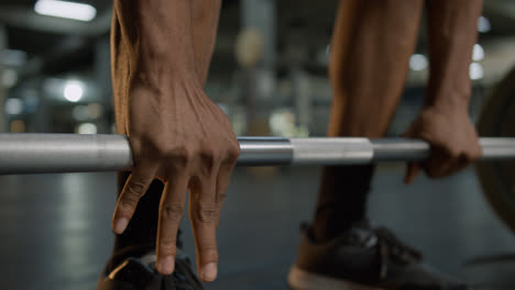 Close-up-view-of-man's-hands-holding-a-barbell