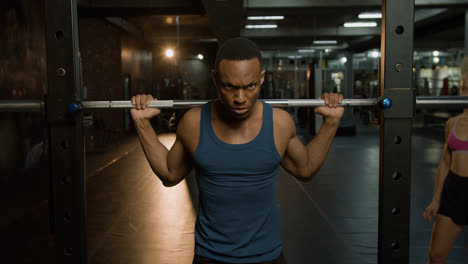Front-view-of-an-athletic-african-american-man-in-the-gym.
